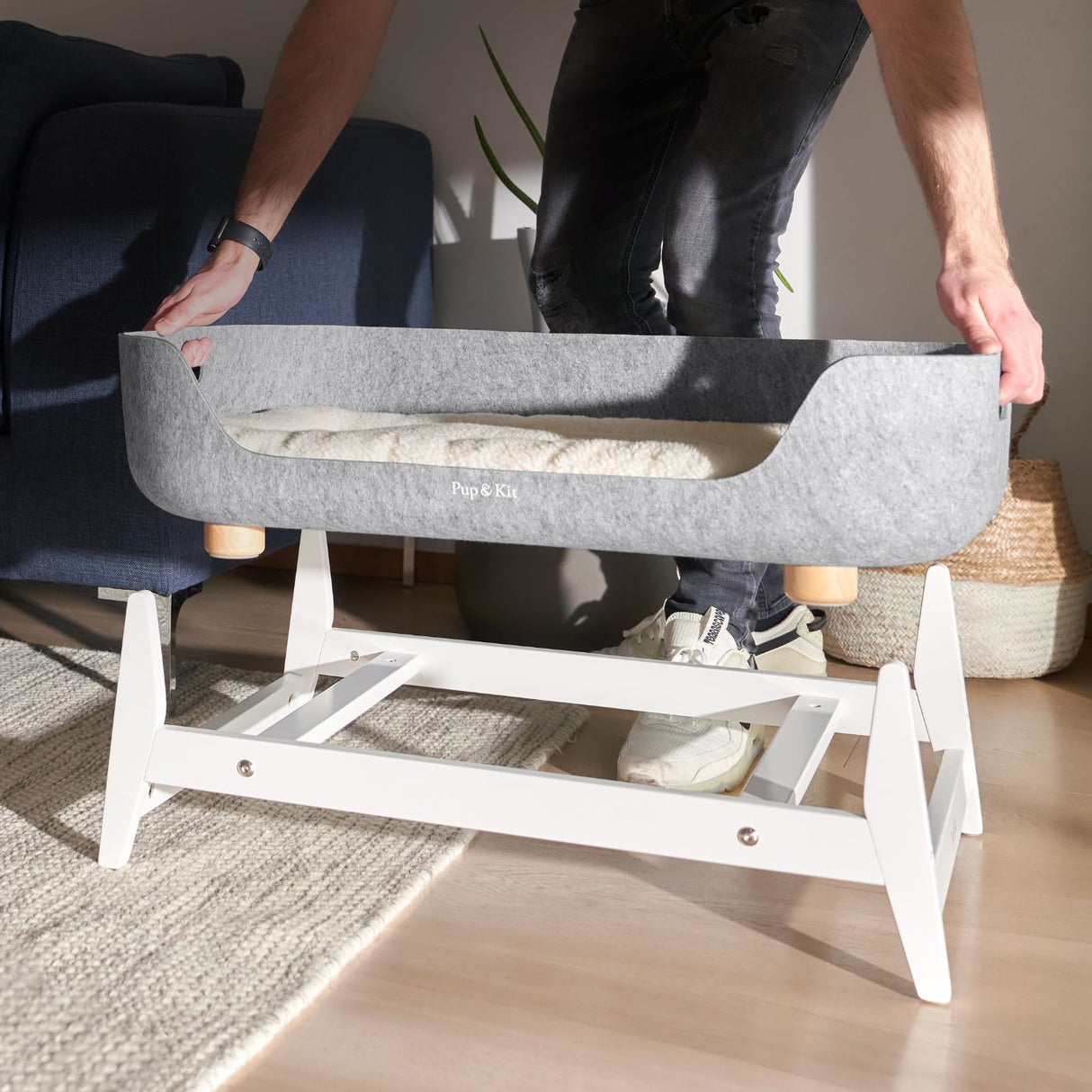 PetNest dog bed in white being put on it's stand